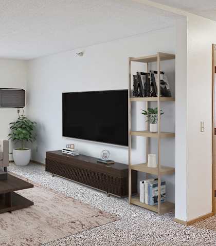 A living room with a white couch, a brown coffee table, and a flat screen TV.