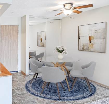 A modern dining room with a white table and chairs.