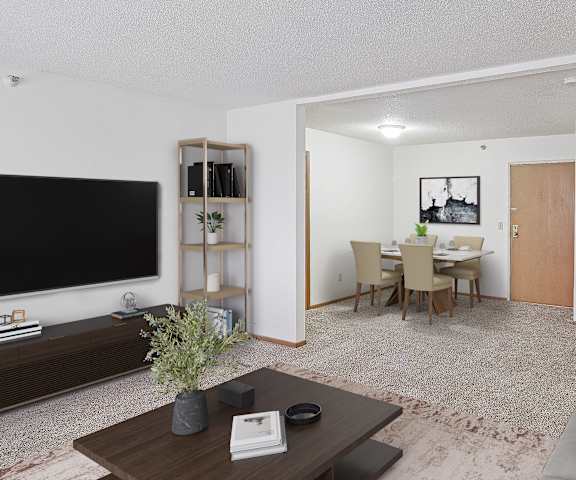 A living room with a grey couch and a wooden coffee table.