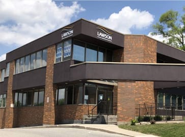 a picture of the front of a building with a blue sky in the background