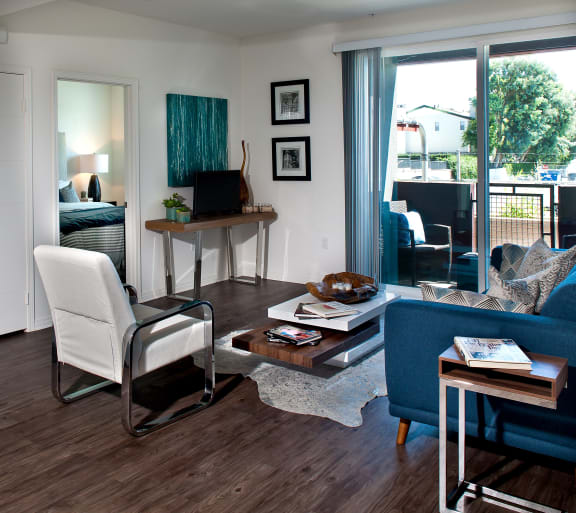 a living room filled with furniture and a large window at Legacy Apartments, Northridge, CA, 91325