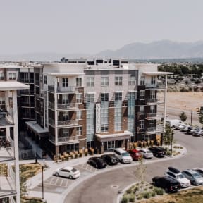 an aerial view of a building with cars parked in front of it