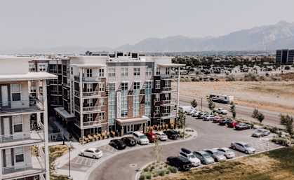 an aerial view of a building with cars parked in front of it