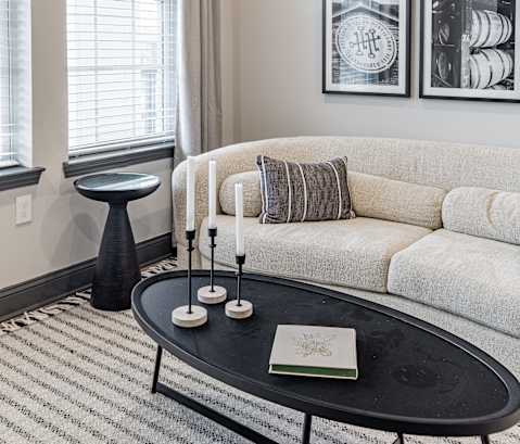 a living room with a couch and a coffee table at The Louis Apartment Flats, Louisville, KY