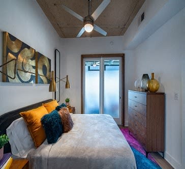 a bedroom with a large bed and a ceiling fan