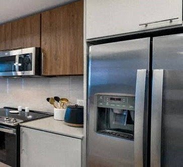 a kitchen with a stainless steel refrigerator and a microwave