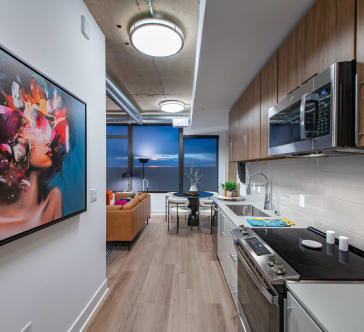 a kitchen and dining room with a large painting on the wall