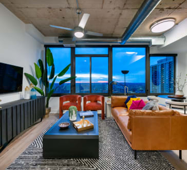 a living room filled with furniture and a large window