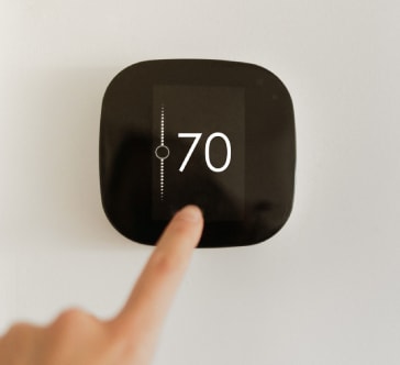 a hand is holding up a receiver with the number 70 on it