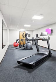 Horicon School's fitness center with cardio equipment, yoga ball, and free weights