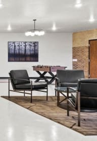 sitting area, TV, and fooseball table in the community room at Horicon School Apartments