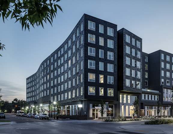 A modern building with a mix of black and white balconies.