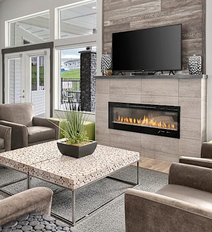 a living room with couches and chairs and a fireplace
