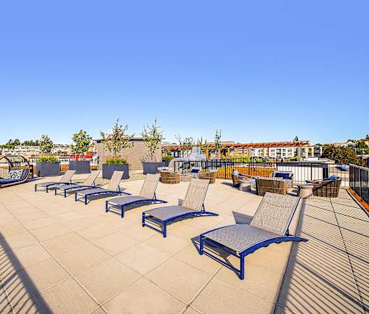 a group of lounge chairs on a roof top patio at The Hayes on Stone Way, Seattle, WA, 98103