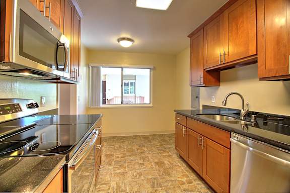 a kitchen with white cabinets and a sink