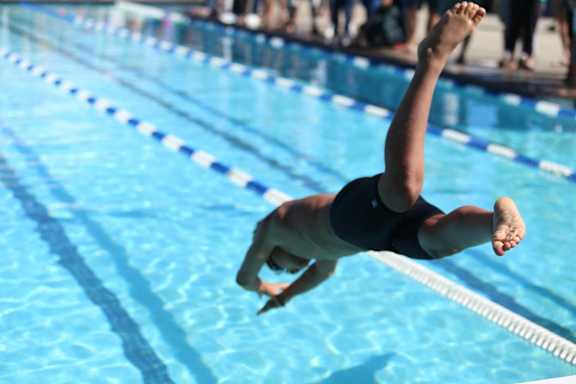 a swimmer diving into a swimming pool