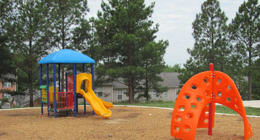 a playground with a swing set and a slide