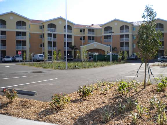 A parking lot in front of apartment buildings.