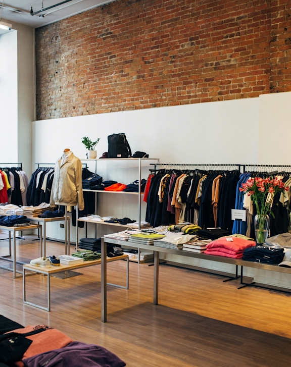 A clothing store with a variety of clothes on display.