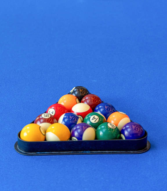 a game of billiards on a blue pool table