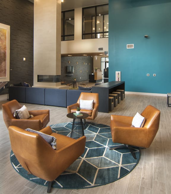 a large living room with blue walls and leather furniture at Cycle Apartments, Colorado, 80525