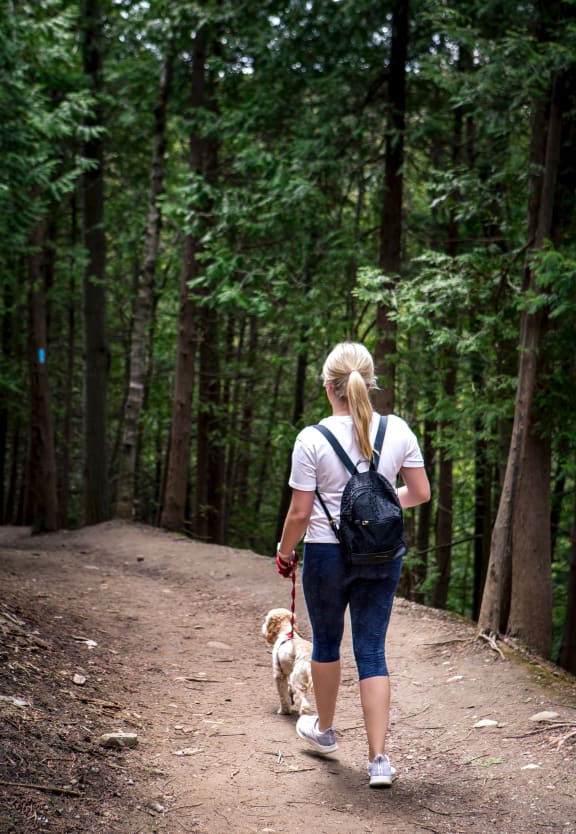 Hiking Woman with Dog at Stone Cliff Apartments