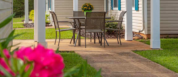 a patio with a table and chairs on it