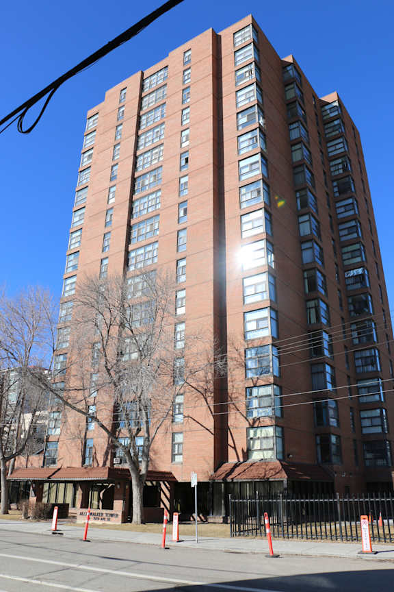 A tall building with a tree in front of it.