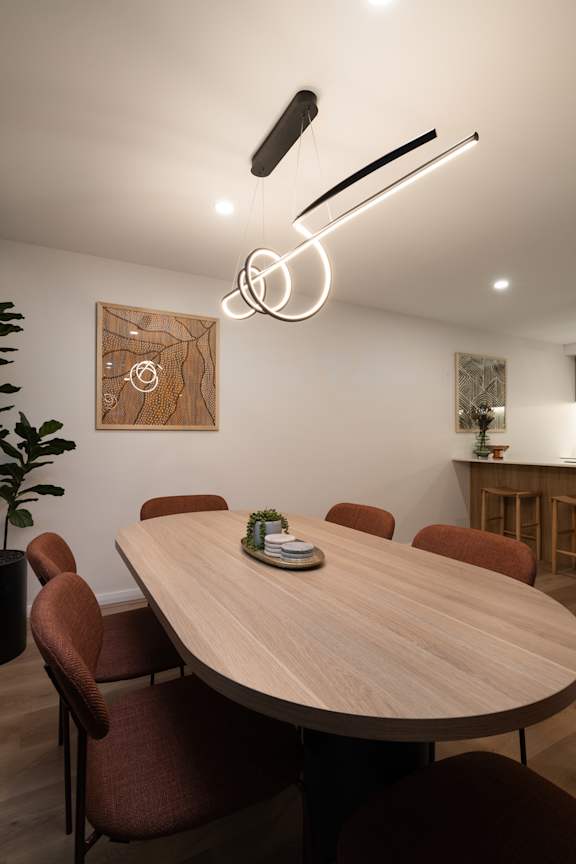 A conference room with a large table and chairs.