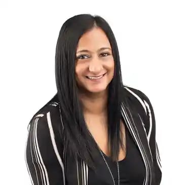a young woman wearing a black and white striped jacket