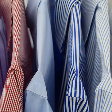 a bunch of ties and shirts in a pile