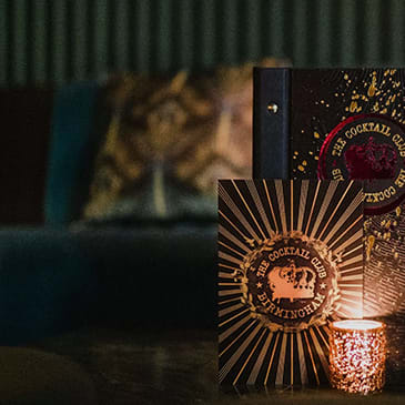 a book on a table next to a candle