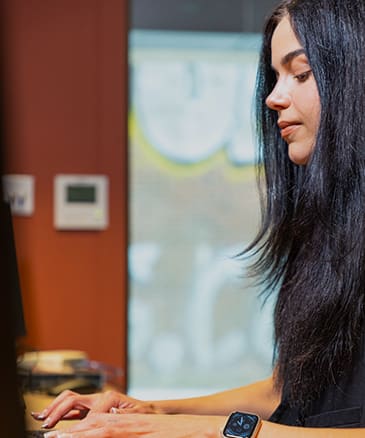 a woman working on a computer at a desk