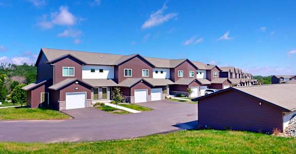 a row of houses on a street with a blue sky