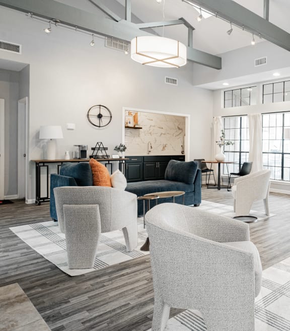 a living room with white walls and white furniture and windows