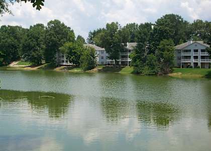 a view of a lake with apartment buildings in the background