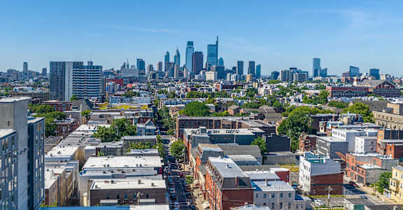A cityscape with a mix of residential and commercial buildings.