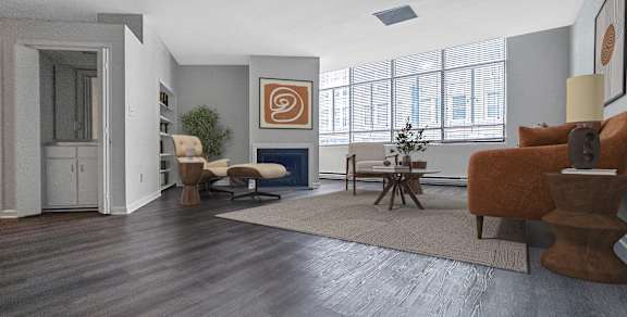 A living room with a brown couch and a wooden floor.