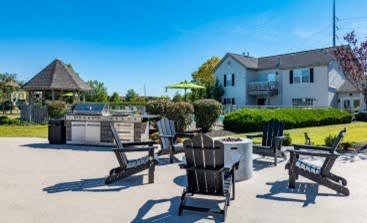 A sunny day at a resort with lounge chairs and a gazebo.