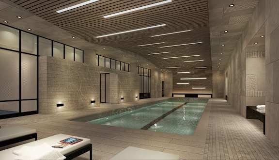 a lobby with a pool and tables