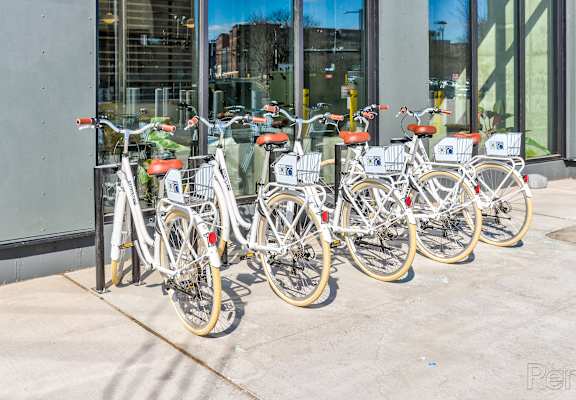 A row of bicycles are parked in front of a building.at The Anthem at Square 10, New Haven, CT 06510