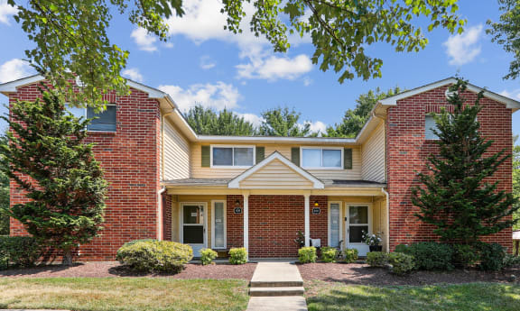 a brick house with two trees in front of it at Villages at Morgan Metro, Landover, MD