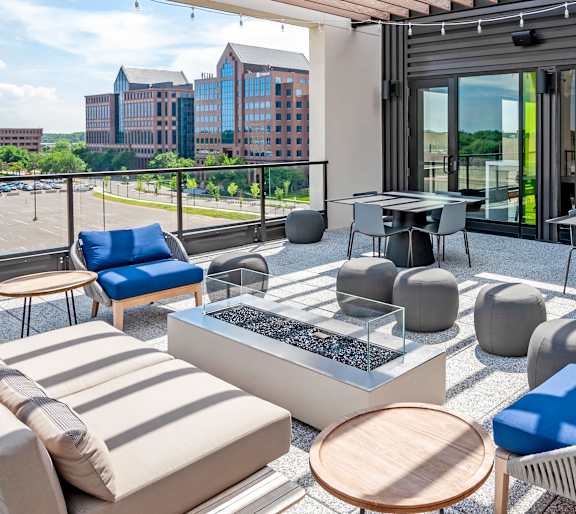 A modern outdoor seating area with a view of the city.