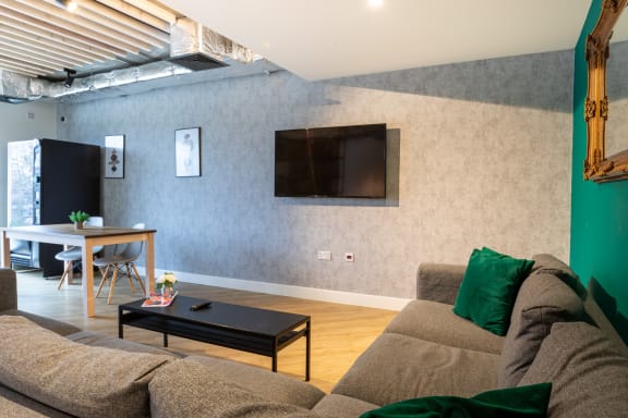 a living room with a couch and a table and a television