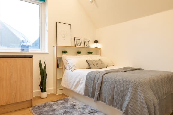 a bedroom with a bed and a desk with a chair