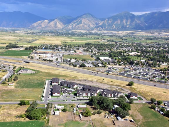 an aerial view of a city with mountains in the background