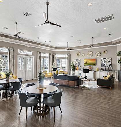 a large living room with a table and chairs and a couch