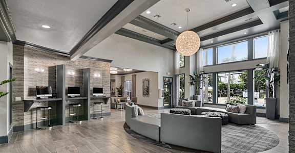 A modern office lobby with a reception desk and seating area.