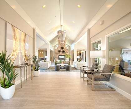 A large lobby with chairs and tables and a chandelier at Andorra