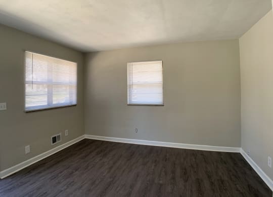 Spacious living room with vinyl flooring  and 2 windows